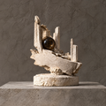 Ivory-toned architectural ruins orb sculpture on a circular base without text